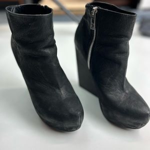 Soft gently distressed nubuc very high heel bootie. Side zip chunk wooden heel